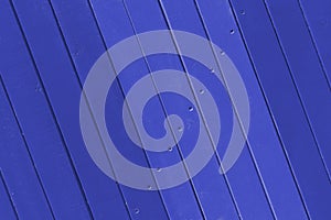 Blue background. Wooden slats in blue shade