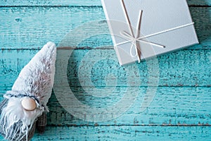 Blue background of a wooden table with a Santa toy on it, copy space