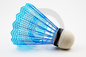 Blue badminton shuttlecock on a white