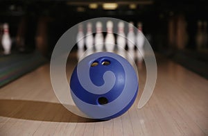 Blue ball on bowling lane in club