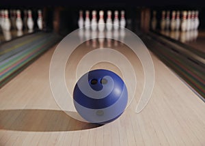 Blue ball on bowling lane in club