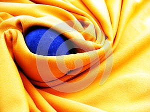 Blue ball of iron in yellow blanket.