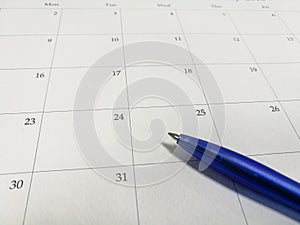 Blue ball pen on the calendar, calendar background