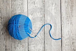 Blue ball of wool yarn for close-up knitting on a white background