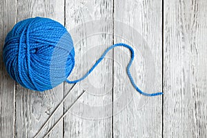 Blue ball of wool yarn for close-up knitting on a white background
