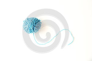 Blue ball of woolen thread on a light background
