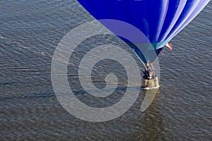 Blue balloon over water