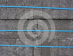 Blue banding straps around concrete blocks