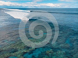 Blue barrel wave in tropical ocean. Aerial view of surfing barrel waves