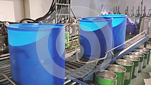 Blue barrels on an automated line in a factory. The process of colorization in the factory