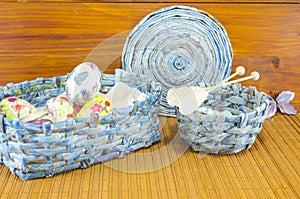 Blue basket full of handcolored Easter Eggs in decoupage