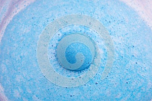 Blue bath bomb foaming in water