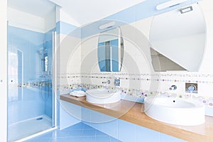 Blue bathroom with double sinks