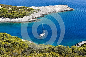 Blue bay with a white sailing boat, Croatia in Europe