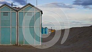 Blue beach sheds near a sand dune on the Mediterranean sea coast Italy, Europe