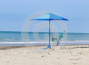 Blue beach  umbrellas and chair