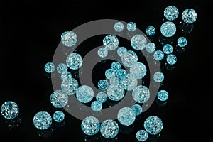 Blue beads balls on black mirror background