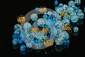 Blue beads balls on black mirror background