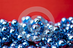 Blue Beads on a Red Background. Copy Space for Text. Macro Close-up. Background of Many Colored Beads Necklace