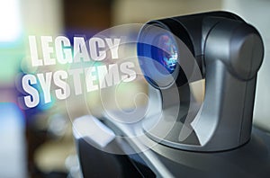 A blue beam glows from the projector inside which is the inscription - Legacy Systems