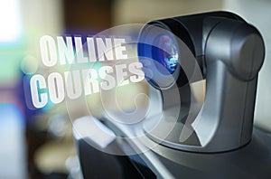 A blue beam glows from the projector inside which is the inscription - Online Courses
