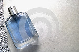 Blue beautiful glass transparent fashionable glamorous bottle of cologne, perfume and ribbon of sparkling rhinestones, diamonds an