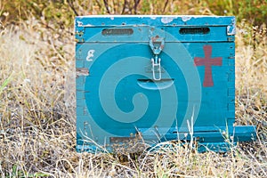 Blue beehive box on the meadow