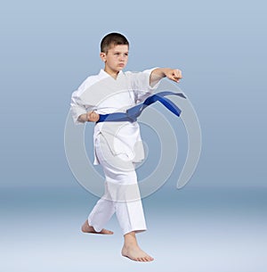 With a blue belt karate athlete beats punch arm