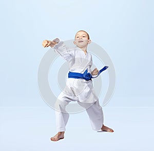 With a blue belt karateka strikes straight punch arm