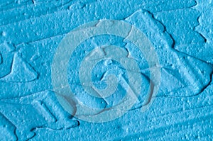 Blue bentonite facial clay mask, face cream, body wrap texture close up, selective focus. Abstract background