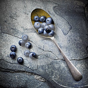 Blue berries and single spoon top view