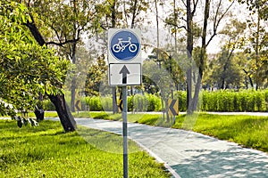 Blue bicycle road sign with one-way street.