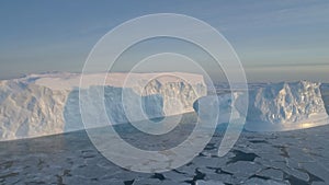 Blue big iceberg aerial shot close-up. White Antarctica