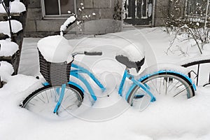 Blue bike covered in snow