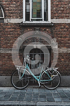 A blue bike parked in an alley in Brugge