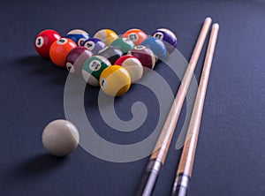 Blue billiard table with all balls and cues.