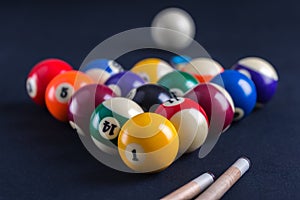 Blue billiard table with balls and cues.