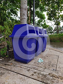 Beside the blue bin is a mask placed next to it