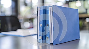 The blue binders on desk.AI generated image