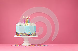 Blue Birthday Cake with Five Candles over Pink Background