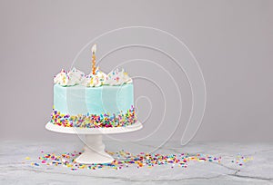 Blue Birthday Cake with sprinkles and Birthday Candle