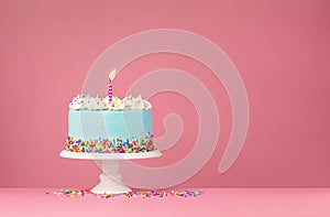 Blue Birthday Cake with Sprinkles and Birthday Candle on pink