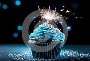 a blue birthday cupcake with a sparkler in the middle