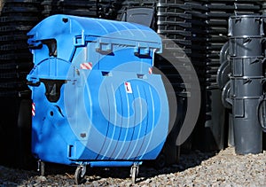 Blue and black municipal waste dust bins