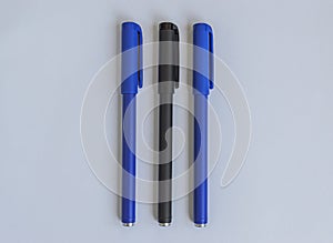 Blue and black penes on a white background