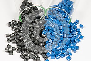 Blue and black polymer pellets in test tubes