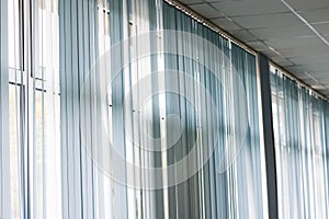 Blue blinds on large windows close up