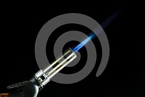 A blue blowtorch tool in action with his blue flame