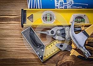 Blue blueprints construction level try square claw hammer pliers