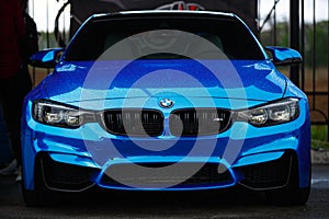 Blue BMW M4 F83 wrapped in blue chrome wrap vinyl on Drift And Car Show. Luxury German vehicle with led